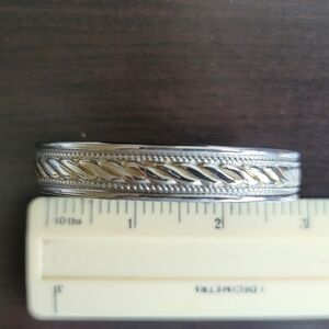 Silver tone bracelet with elegant carvings